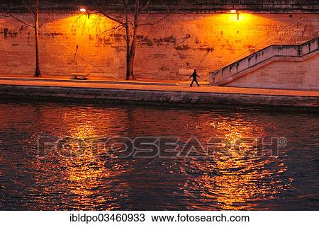 "A lone pedestrian walking along the Seine river, Paris, Ile-de-France, France, Europe" View Large Photo Image Stock Image - "A lone pedestrian walking along the Seine river, Paris, Ile-de-France, France, Europe". Fotosearch