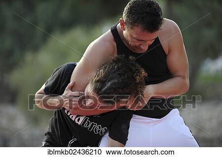 A man and a woman in martial arts training in a park View Large Photo Image Stock Image - A man and a woman in martial arts training in a park. Fotosearch