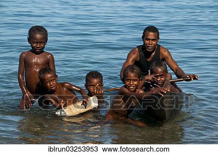 "A man and children with a canoe, Savo Island, Central Province, Solomon Islands, Oceania" View Large Photo Image Stock Image - "A man and children with a canoe, Savo Island, Central Province, Solomon Islands, Oceania". Fotosearch