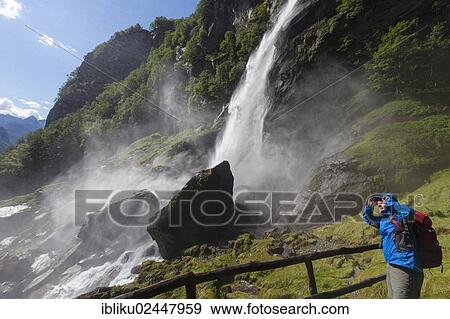 Stock Photo - "A man hiking at the waterfall of Foroglio, Bavona Valley, Val Bavona, Maggia Valley, Valle Maggia, Ticino, Switzerland, Europe". Fotosearch