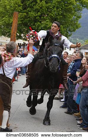 "A man is handing a competitor a wreath of flowers, Kufenstechen, a traditional custom and festival, Feistritz an der Gail, Villach-Land District, Carinthia, Austria, Europe" View Large Photo Image Stock Photography - "A man is handing a competitor a wreath of flowers, Kufenstechen, a traditional custom and festival, Feistritz an der Gail, Villach-Land District, Carinthia, Austria, Europe". Fotosearch
