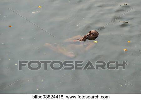 "A man is performing padmasana, lotus position, swimming in the holy waters of the river Godwari, Nasik, Maharashtra, India, Asia" View Large Photo Image Stock Photography - "A man is performing padmasana, lotus position, swimming in the holy waters of the river Godwari, Nasik, Maharashtra, India, Asia". Fotosearch