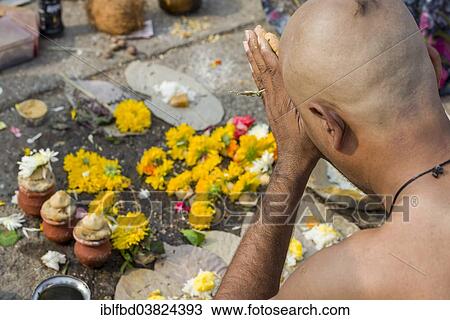 "A man is praying during Dashkriya or Asthi Visarjan, a ritual which is performed 10 days after the death of a family member, Nasik, Maharashtra, India, Asia" View Large Photo Image Stock Image - "A man is praying during Dashkriya or Asthi Visarjan, a ritual which is performed 10 days after the death of a family member, Nasik, Maharashtra, India, Asia". Fotosearch