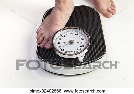 A man stepping on bathroom scales View Large Photo Image Stock Photograph - A man stepping on bathroom scales. Fotosearch
