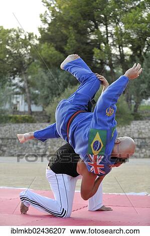 A martial arts instructor is demonstrating a shoulder throw with a student View Large Photo Image Stock Photo - A martial arts instructor is demonstrating a shoulder throw with a student. Fotosearch