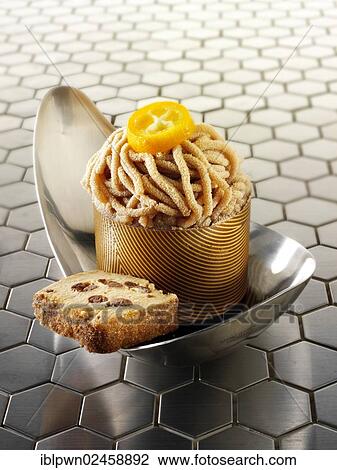 Stock Image - A modern Japanese cake with a patterned chocolate case and piped chestnut puree with cumquat sauce. Fotosearch