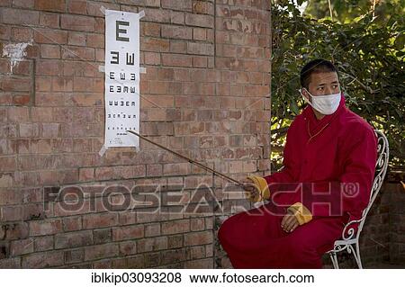 "A monk from Amitabha Monastery carrying out a vision test for poor villagers, Amitabha monastery, Nepal, Asia" View Large Photo Image Stock Photo - "A monk from Amitabha Monastery carrying out a vision test for poor villagers, Amitabha monastery, Nepal, Asia". Fotosearch