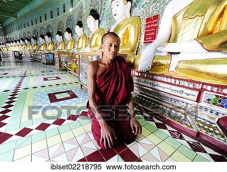 "A monk kneeling in front of Buddha statues in a monastery, Umin Thounzeh Pagoda, Sagaing, Mandalay, Burma also known as Myanmar, Southeast Asia, Asia" View Large Photo Image Stock Photography - "A monk kneeling in front of Buddha statues in a monastery, Umin Thounzeh Pagoda, Sagaing, Mandalay, Burma also known as Myanmar, Southeast Asia, Asia". Fotosearch