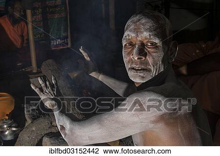 "A newly initiated Shiva sadhu from Avahan Akhara, sitting around a bonfire, during Kumbha Mela festival, Allahabad, Uttar Pradesh, India, Asia" View Large Photo Image Stock Image - "A newly initiated Shiva sadhu from Avahan Akhara, sitting around a bonfire, during Kumbha Mela festival, Allahabad, Uttar Pradesh, India, Asia". Fotosearch