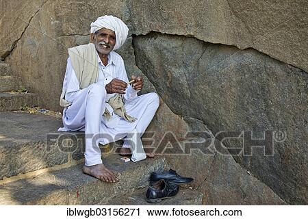 "A pilgrim dressed in white is sitting on the stairs leading up to the temple on the holy mountain of Girnar, Junagadh, Gujarat, India, Asia" View Large Photo Image Stock Image - "A pilgrim dressed in white is sitting on the stairs leading up to the temple on the holy mountain of Girnar, Junagadh, Gujarat, India, Asia". Fotosearch
