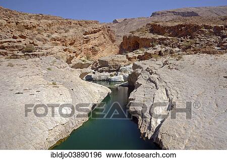 "A pool filled with green water surrounded by the rocks of the desert, Wadi Bani Khalid, Muqal, Ash Sharqiyah, Oman, Asia" View Large Photo Image Stock Photograph - "A pool filled with green water surrounded by the rocks of the desert, Wadi Bani Khalid, Muqal, Ash Sharqiyah, Oman, Asia". Fotosearch