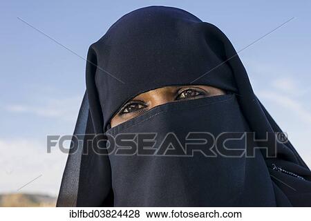 Stock Photo - "A portrait of a young veiled Muslim woman visiting the Bibi Ka Maqbara, Aurangabad, Maharashtra, India, Asia". Fotosearch