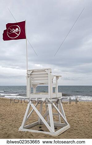 "A red flag on a lifeguard's chair at Nauset Light Beach in Cape Cod National Seashore indicates that swimming is prohibited; closed beach due to bacterial contamination of the water, Eastham, Massachusetts, USA" View Large Photo Image Stock Photography - "A red flag on a lifeguard's chair at Nauset Light Beach in Cape Cod National Seashore indicates that swimming is prohibited; closed beach due to bacterial contamination of the water, Eastham, Massachusetts, USA". Fotosearch