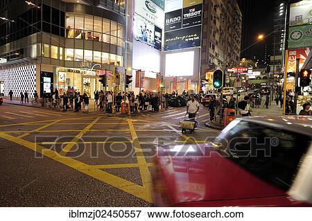 "A red taxi driving on a street in Tsim Sha Tsui in the evening, Kowloon, Hong Kong, China, Asia" View Large Photo Image Stock Photo - "A red taxi driving on a street in Tsim Sha Tsui in the evening, Kowloon, Hong Kong, China, Asia". Fotosearch