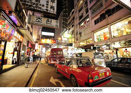 "A red taxi on a street in the Tsim Sha Tsui district in the evening, Kowloon, Hong Kong, China, Asia" View Large Photo Image Stock Photo - "A red taxi on a street in the Tsim Sha Tsui district in the evening, Kowloon, Hong Kong, China, Asia". Fotosearch