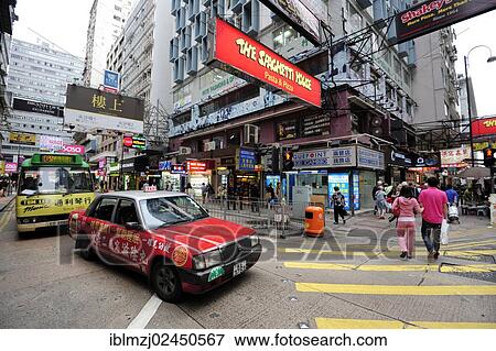 "A red taxi waiting at a zebra crossing on a street in the Tsim Sha Tsui district, Kowloon, Hong Kong, China, Asia" View Large Photo Image Stock Photo - "A red taxi waiting at a zebra crossing on a street in the Tsim Sha Tsui district, Kowloon, Hong Kong, China, Asia". Fotosearch