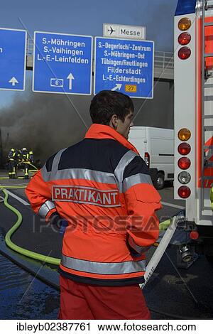 "A rescue service intern is watching a truck fire on the A8 motorway near the """"Echterdinger Ei"""" junction, Stuttgart, Baden-Wuerttemberg, Germany, Europe" View Large Photo Image Stock Image - "A rescue service intern is watching a truck fire on the A8 motorway near the """"Echterdinger Ei"""" junction, Stuttgart, Baden-Wuerttemberg, Germany, Europe". Fotosearch