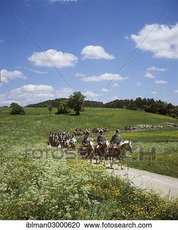 Stock Image - "A ride on horseback at Whitsun, Egling, Egling, Upper Bavaria, Bavaria, Germany, Europe". Fotosearch