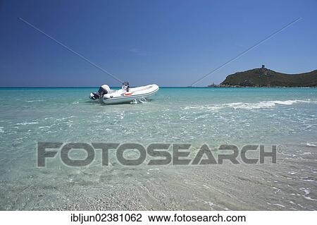 "A rubber dinghy anchored in front of the ruins of the Saracen tower on the beach of Cala Porto Giunco, Capo Cabonara, Villasimius, Sarrabus, Province of Cagliari, Sardinia, Italy, Europe" View Large Photo Image Stock Image - "A rubber dinghy anchored in front of the ruins of the Saracen tower on the beach of Cala Porto Giunco, Capo Cabonara, Villasimius, Sarrabus, Province of Cagliari, Sardinia, Italy, Europe". Fotosearch