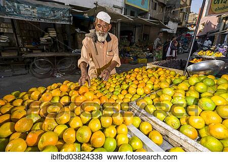 "A salesman is offering oranges at the market, Ahmedabad, Gujarat, India, Asia" View Large Photo Image Stock Photo - "A salesman is offering oranges at the market, Ahmedabad, Gujarat, India, Asia". Fotosearch