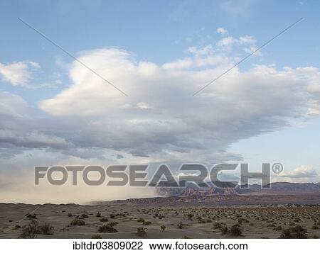 Stock Image - "A sand storm over the Mesquite Flat Sand Dunes and the Amargosa Range in the evening, Death Valley, Death Valley National Park, California, USA". Fotosearch