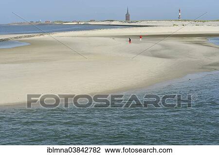 Stock Image - "A sandbar at the harbor, Westturm tower and the lighthouse at the back, Wangerooge, Friesland, Lower Saxony, Germany, Europe". Fotosearch