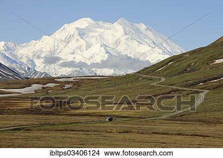 "A shuttle bus from the Denali National Park and Preserve crossing the tundra with views of Mt McKinley at back, Denali National Park, Alaska, United States, North America" View Large Photo Image Picture - "A shuttle bus from the Denali National Park and Preserve crossing the tundra with views of Mt McKinley at back, Denali National Park, Alaska, United States, North America". Fotosearch