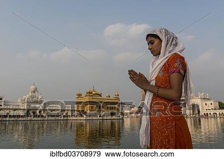 "A Sikh devotee praying at the holy pool of the Harmandir Sahib or Golden Temple, a holy Sikh temple, Amritsar, Punjab, India, Asia" View Large Photo Image Stock Photo - "A Sikh devotee praying at the holy pool of the Harmandir Sahib or Golden Temple, a holy Sikh temple, Amritsar, Punjab, India, Asia". Fotosearch