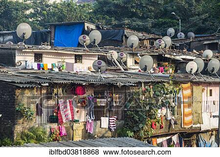 Stock Photo - "A slum area with houses made from corrugated iron sheets, with TV dishes on the roofs, Mumbai, Maharashtra, India, Asia". Fotosearch