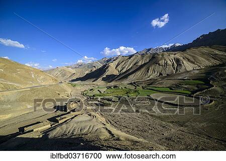 Stock Image - "A small village with green fields in a barren landscape at an altitude of 4. 000 m, Lamayuru, Ladakh, Jammu and Kashmir, India, Asia". Fotosearch