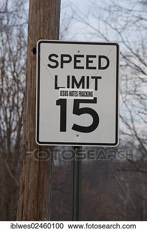Stock Image - "A sticker on a road sign near a natural gas well in the process of hydraulic fracturing or fracking in rural Lycoming County, Williamsport, Pennsylvania, United States, North America". Fotosearch