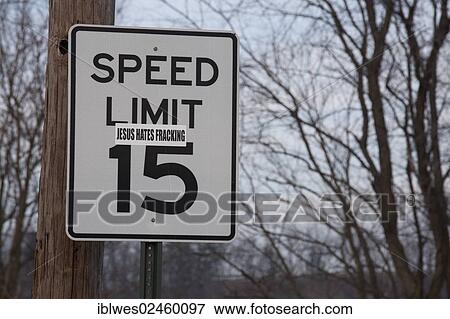 Stock Photo - "A sticker on a road sign near a natural gas well in the process of hydraulic fracturing or fracking in rural Lycoming County, Williamsport, Pennsylvania, United States, North America". Fotosearch