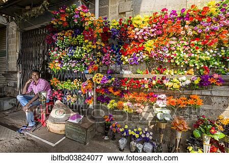 Stock Photo - "A street vendor is selling colorful artificial flowers, Bhavnagar, Gujarat, India, Asia". Fotosearch