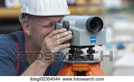 "A structural engineer is taking measurements of a possible soil dropping during a building site load test, at a construction site in Fridolfing, Bavaria, Germany, Europe" View Large Photo Image Picture - "A structural engineer is taking measurements of a possible soil dropping during a building site load test, at a construction site in Fridolfing, Bavaria, Germany, Europe". Fotosearch