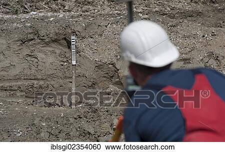 "A structural engineer is taking measurements of a possible soil dropping during a building site load test, at a construction site in Fridolfing, Bavaria, Germany, Europe" View Large Photo Image Stock Image - "A structural engineer is taking measurements of a possible soil dropping during a building site load test, at a construction site in Fridolfing, Bavaria, Germany, Europe". Fotosearch
