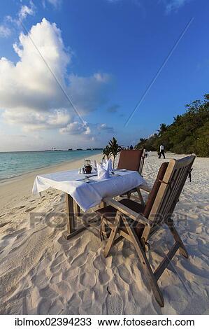 "A table laid for dinner standing on the beach, Paradise Island at the back, Lankanfinolhu, North Male Atoll, Republic of Maldives, Indian Ocean, Asia" View Large Photo Image Stock Image - "A table laid for dinner standing on the beach, Paradise Island at the back, Lankanfinolhu, North Male Atoll, Republic of Maldives, Indian Ocean, Asia". Fotosearch