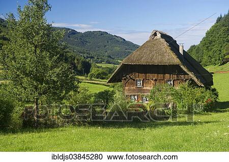 Stock Image - "A thatched farmhouse and a cottage garden, Gutachtal valley, Black Forest, Baden-Wurttemberg, Germany, Europe". Fotosearch