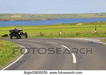 Stock Photography - "A Tin Lizzie, Ford Model T, on the road at the bay of Scapa Flow, South Ronaldsay, Orkney, Scotland, United Kingdom, Europe". Fotosearch
