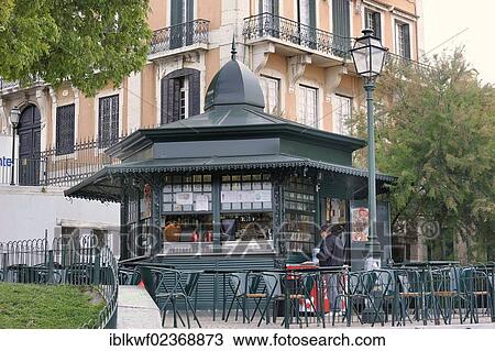 "A typical cast iron polygonal kiosk, chairs and tables standing in front of it, Bairro Alto, Lisbon, Portugal, Europe" View Large Photo Image Stock Image - "A typical cast iron polygonal kiosk, chairs and tables standing in front of it, Bairro Alto, Lisbon, Portugal, Europe". Fotosearch