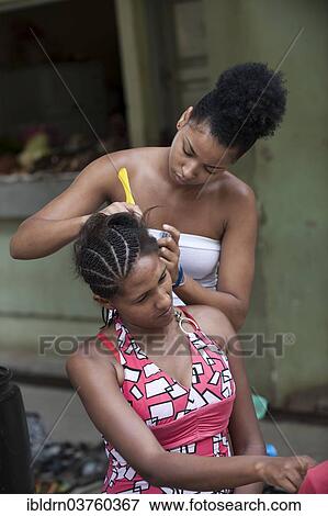 "A woman dressing a girlfriend's hair, Praia, Santiago Island, Cape Verde, Africa" View Large Photo Image Stock Photo - "A woman dressing a girlfriend's hair, Praia, Santiago Island, Cape Verde, Africa". Fotosearch