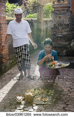 "A woman during the daily ceremony of sacrificial offerings in front of a house, Ubud, Bali, Indonesia, Asia" View Large Photo Image Stock Photography - "A woman during the daily ceremony of sacrificial offerings in front of a house, Ubud, Bali, Indonesia, Asia". Fotosearch