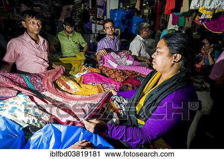 Stock Image - "A woman is buying material at Mangaldas Market, Mumbai, Maharashtra, India, Asia". Fotosearch