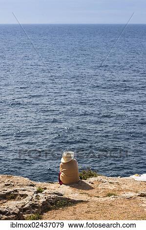 "A woman looking out to the sea, coast at Cala Pi, Mallorca, Majorca, Balearic Islands, Mediterranean Sea, Spain, Europe" View Large Photo Image Stock Photo - "A woman looking out to the sea, coast at Cala Pi, Mallorca, Majorca, Balearic Islands, Mediterranean Sea, Spain, Europe". Fotosearch