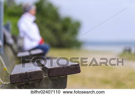 "A woman sitting on a bench on the Baltic coast, Poel island, Mecklenburg-Western Pomerania, Germany, Europe" View Large Photo Image Stock Image - "A woman sitting on a bench on the Baltic coast, Poel island, Mecklenburg-Western Pomerania, Germany, Europe". Fotosearch