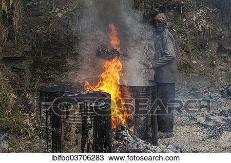 "A worker heating tar in barrels with an open fire at a road construction site, Shimla, Himachal Pradesh, India, Asia" View Large Photo Image Stock Image - "A worker heating tar in barrels with an open fire at a road construction site, Shimla, Himachal Pradesh, India, Asia". Fotosearch