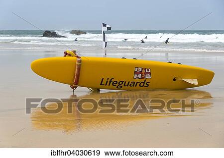 "A yellow surfboard of the lifeguards is lying on the beach, English Channel, Polperro, Cornwall, England, United Kingdom, Europe" View Large Photo Image Stock Photo - "A yellow surfboard of the lifeguards is lying on the beach, English Channel, Polperro, Cornwall, England, United Kingdom, Europe". Fotosearch