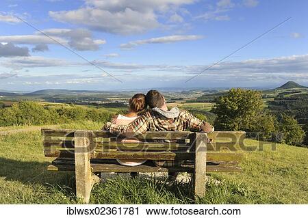 "A young couple sitting on a bench, Hegaublick, Baden-Wuerttemberg, Germany, Europe, PublicGround, Europe" View Large Photo Image Stock Image - "A young couple sitting on a bench, Hegaublick, Baden-Wuerttemberg, Germany, Europe, PublicGround, Europe". Fotosearch