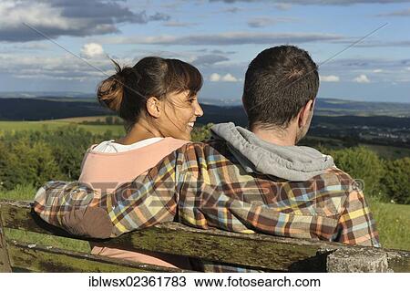 "A young couple sitting on a bench, Hegaublick, Baden-Wuerttemberg, Germany, Europe, PublicGround, Europe" View Large Photo Image Stock Image - "A young couple sitting on a bench, Hegaublick, Baden-Wuerttemberg, Germany, Europe, PublicGround, Europe". Fotosearch