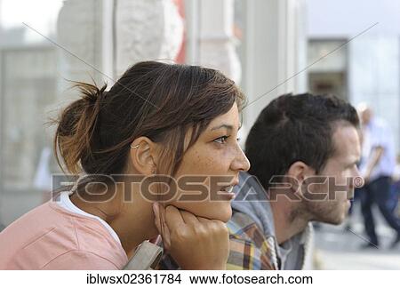 "A young couple sitting side by side, looking in the same direction, Konstanz or Constance, Baden-Wuerttemberg, Germany, Europe, PublicGround, Europe" View Large Photo Image Picture - "A young couple sitting side by side, looking in the same direction, Konstanz or Constance, Baden-Wuerttemberg, Germany, Europe, PublicGround, Europe". Fotosearch