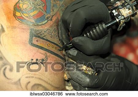 "A young man is getting a tattoo, Freiburg im Breisgau, Baden-Wurttemberg, Germany, Europe" View Large Photo Image Stock Photograph - "A young man is getting a tattoo, Freiburg im Breisgau, Baden-Wurttemberg, Germany, Europe". Fotosearch